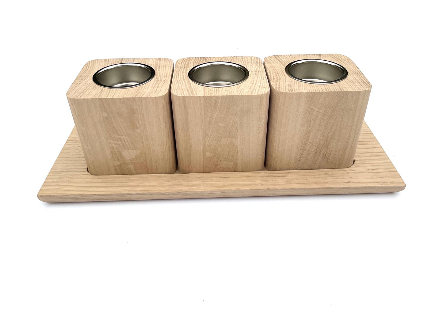 Set of three oak tea light holders with nickel coloured inserts and oak tray