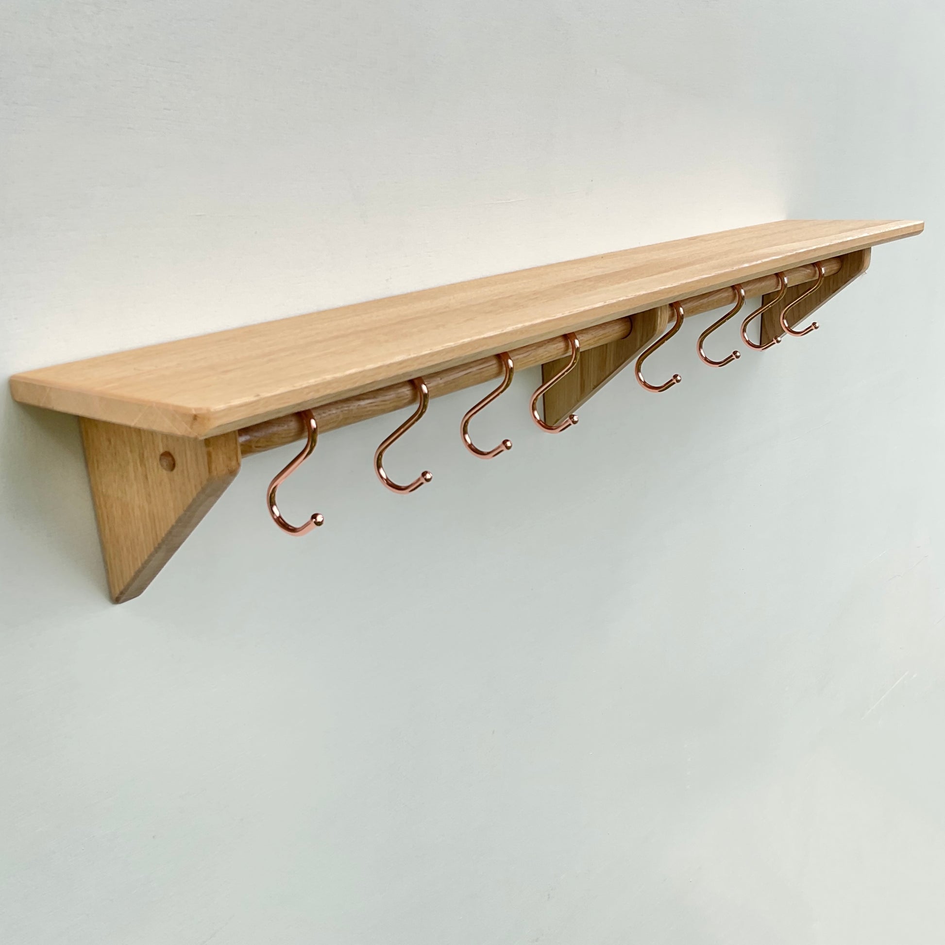 Oak kitchen utensil rail and shelf with copper utensil hooks