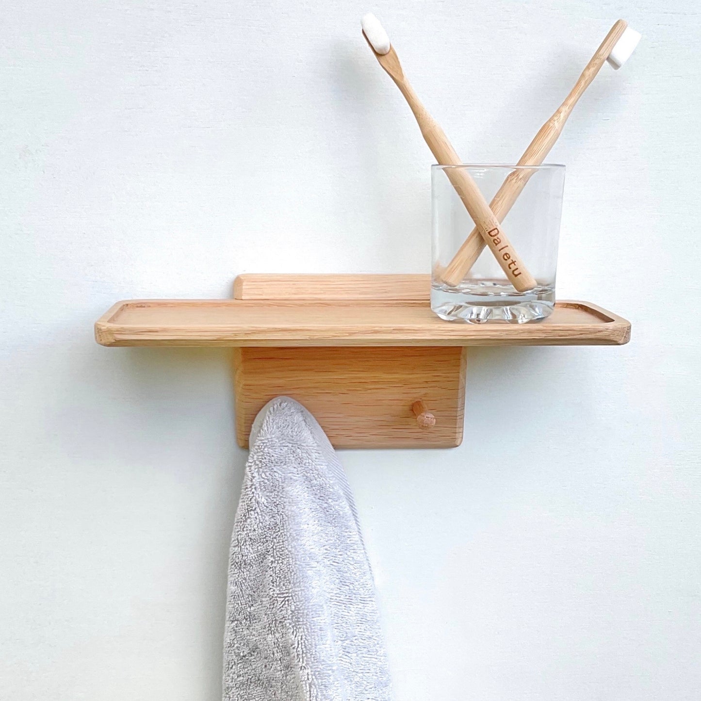 Oak shelf with towel hanging pegs