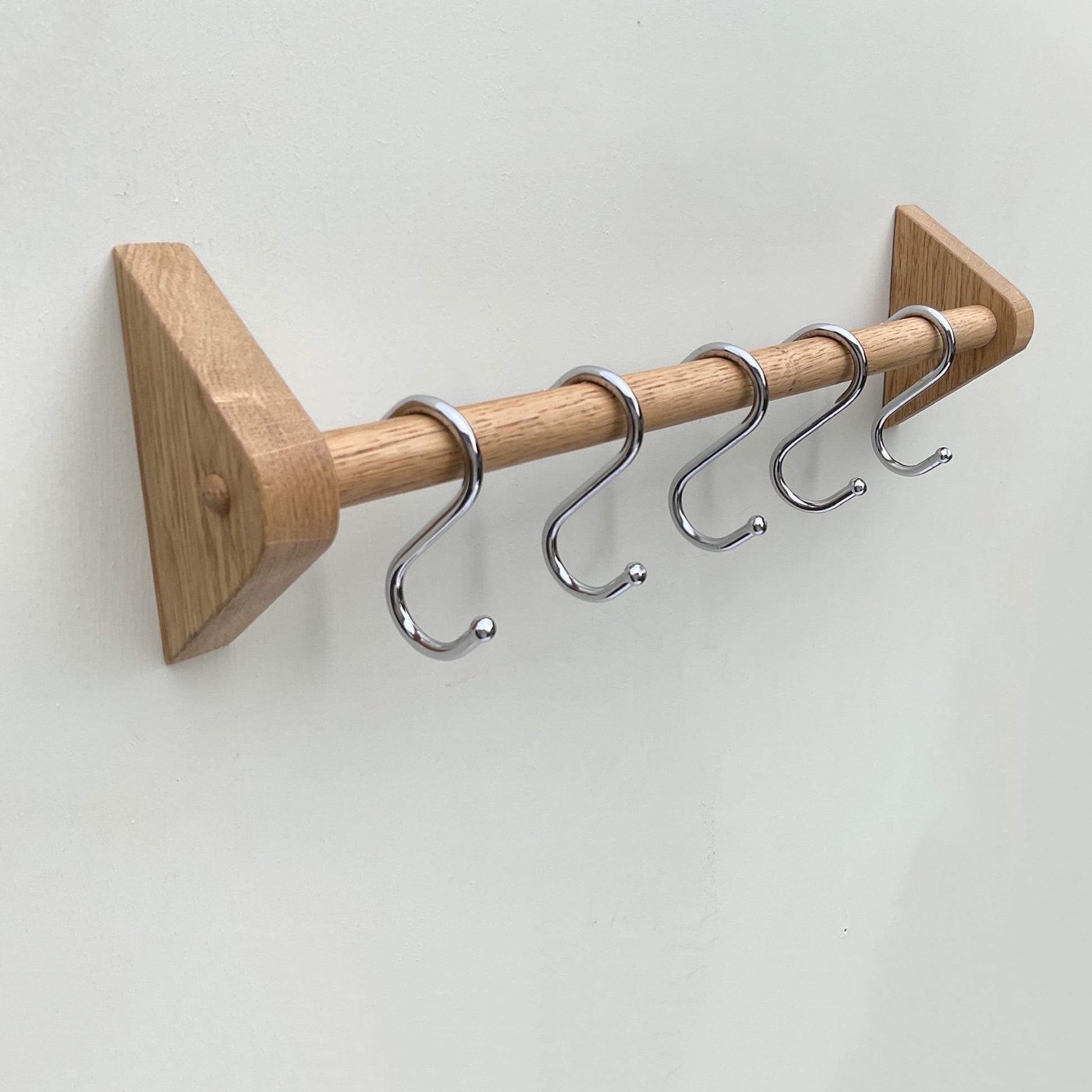 Chrome ball end S hooks on oak kitchen utensil rail 