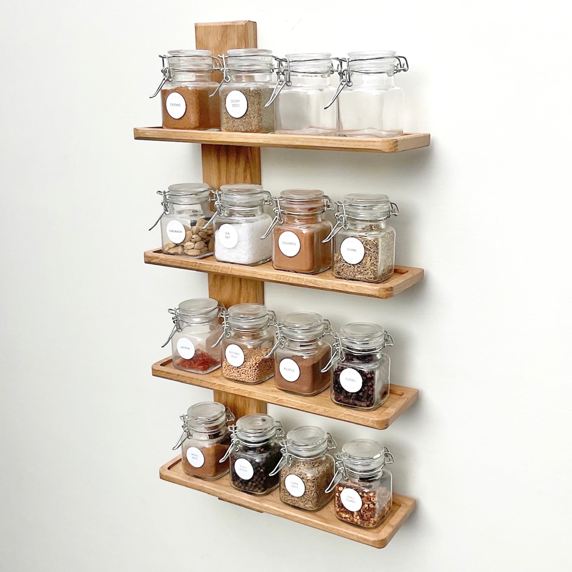 Four shelf oak spice rack with herb and spice jars